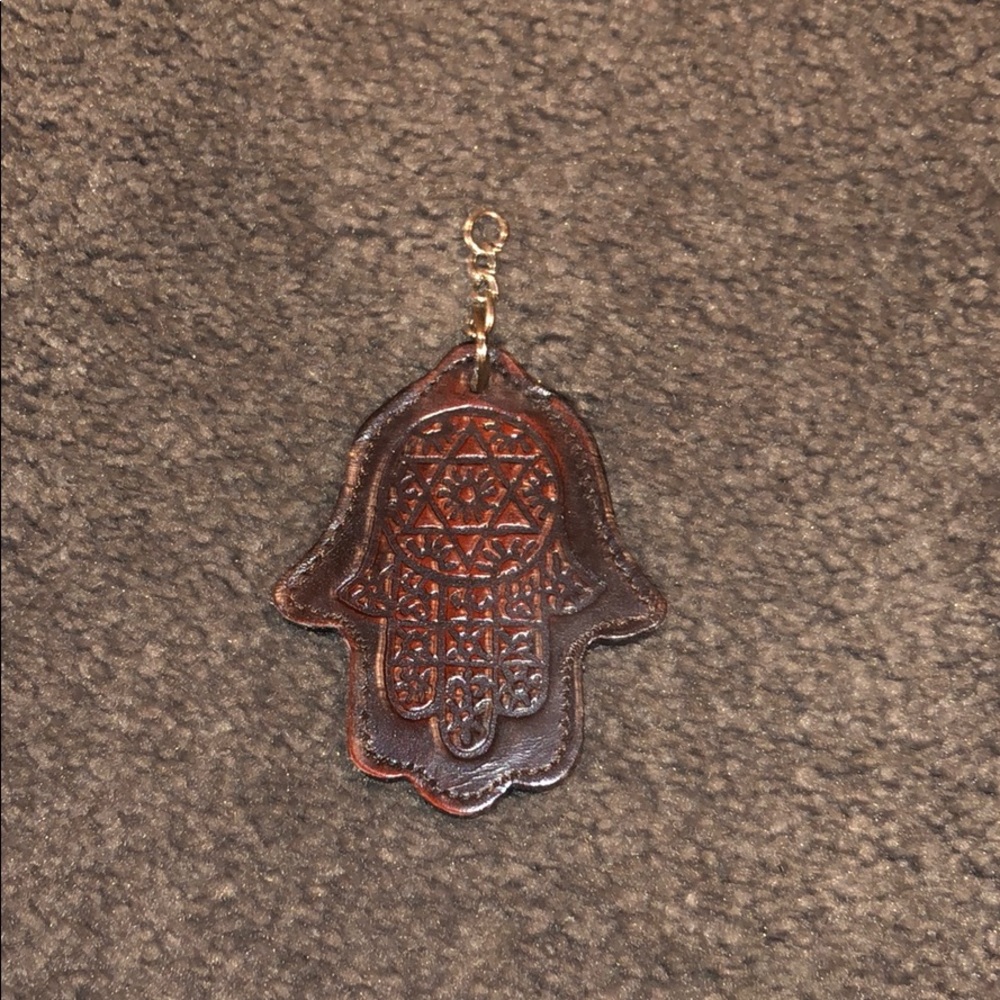 Rust colored hamsa keychain with Hebrew writing